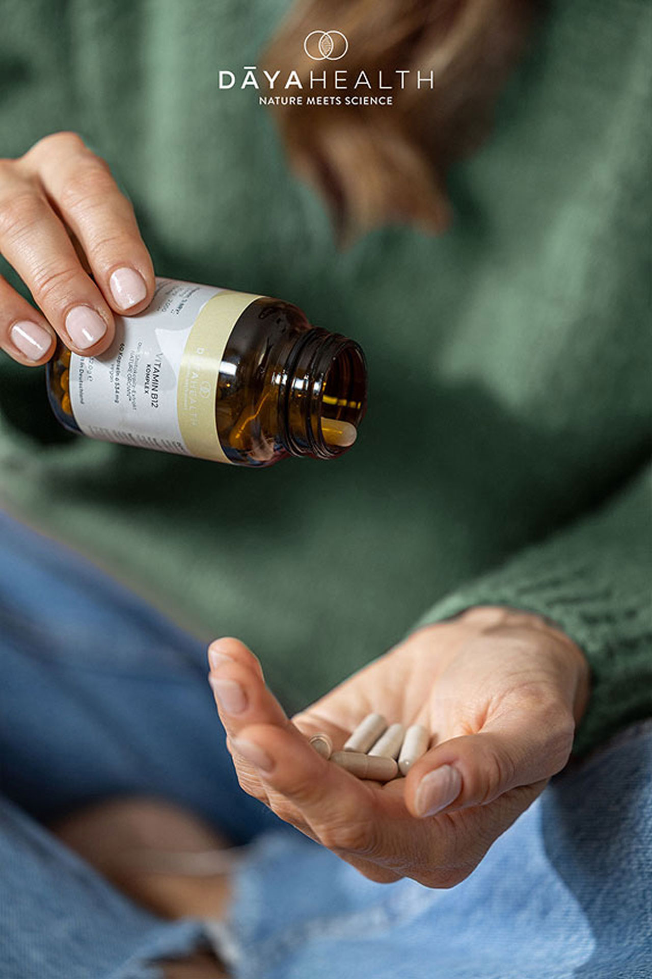 Eine Person gießt Nahrungsergänzungsmittel aus einem Glas in die Hand. DAYAHEALTH.