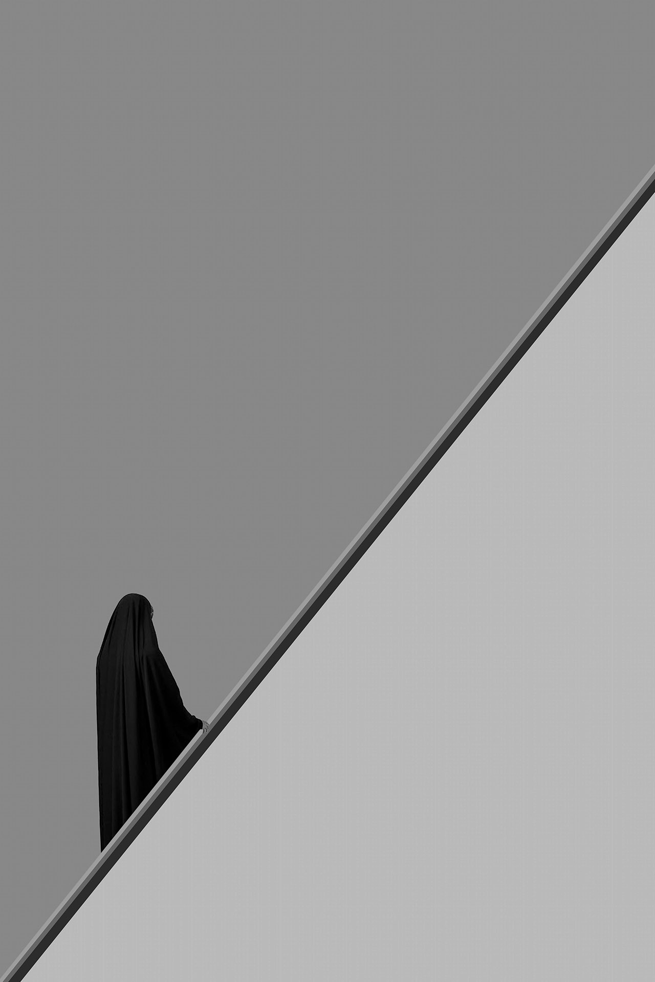 Person in black attire on stairs